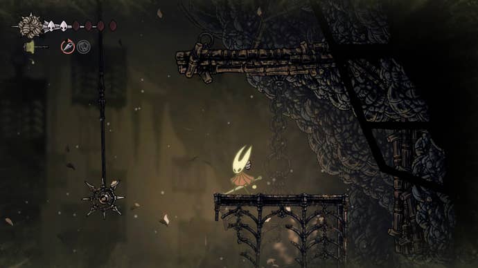 Hornet, poisoned, stands on a platform beside a spiked wheel trap in Sinner's Road in Hollow Knight: Silksong