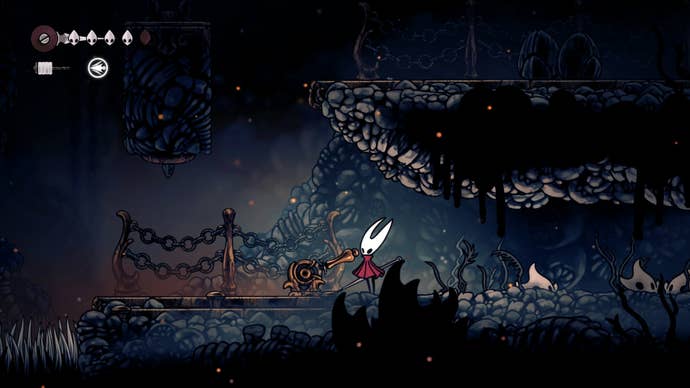 Hornet stands beside a lever that moves a crate in The Marrow in Hollow Knight: Silksong