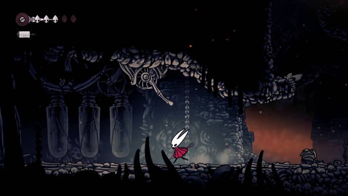 Hornet stands beneath a lever that opens the gate to The Marrow in Hollow Knight: Silksong