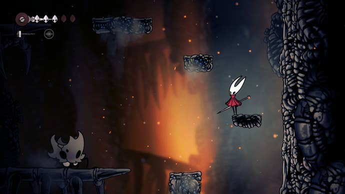 Hornet stands on a ledge with a large skull enemy beneath her in The Marrow in Hollow Knight: Silksong