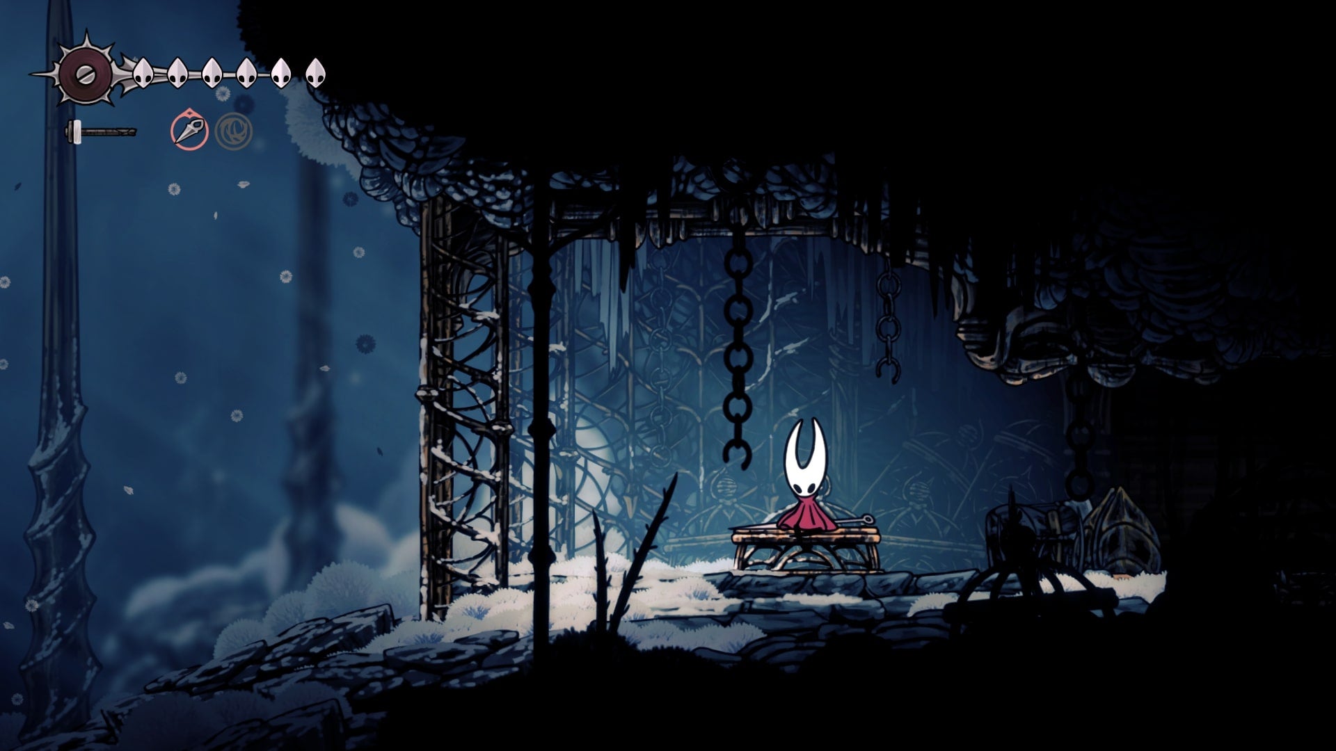 Hornet rests at a Bench in The Slab in Hollow Knight: Silksong