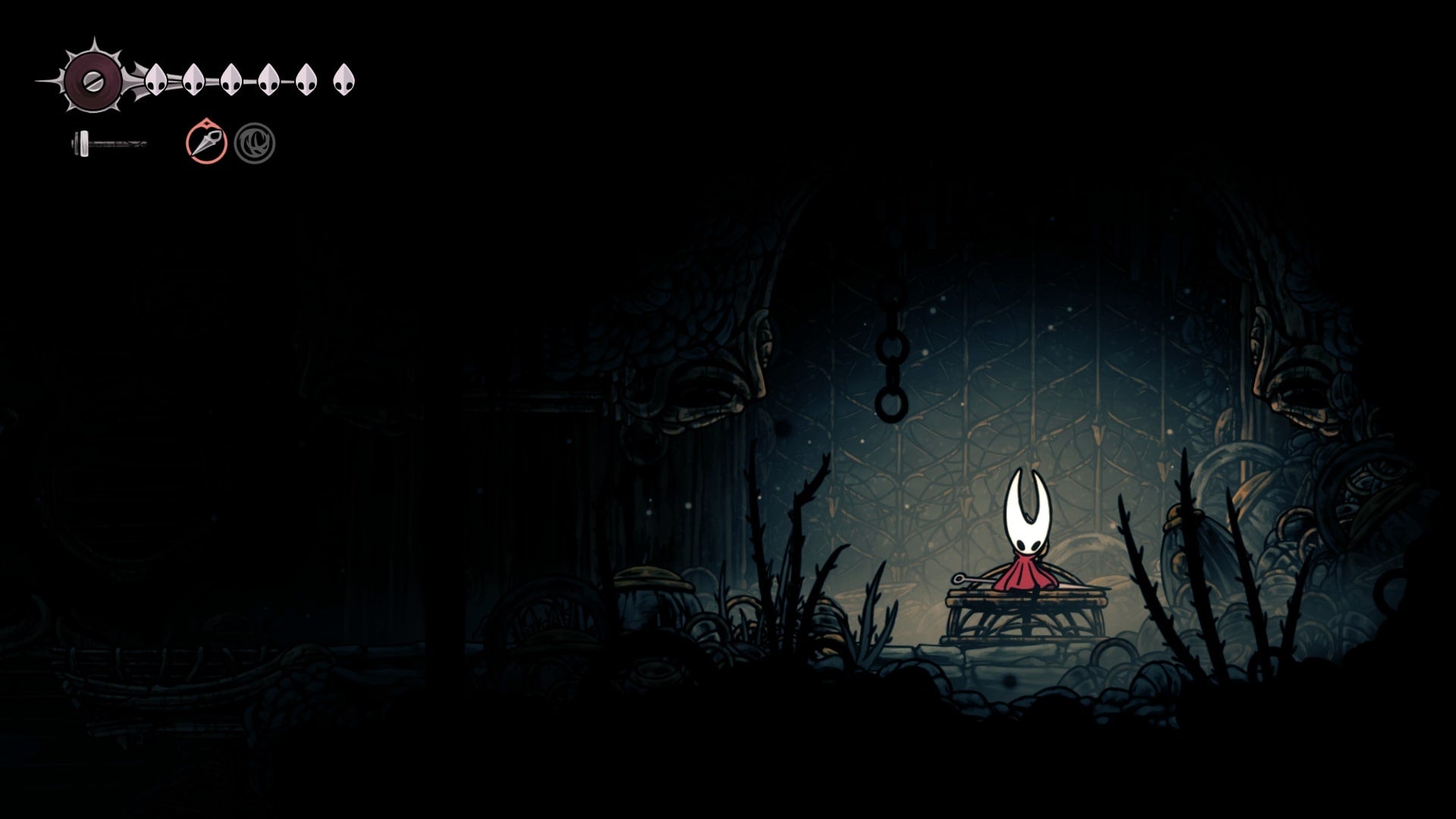 Hornet rests at a Bench in The Slab in Hollow Knight: Silksong