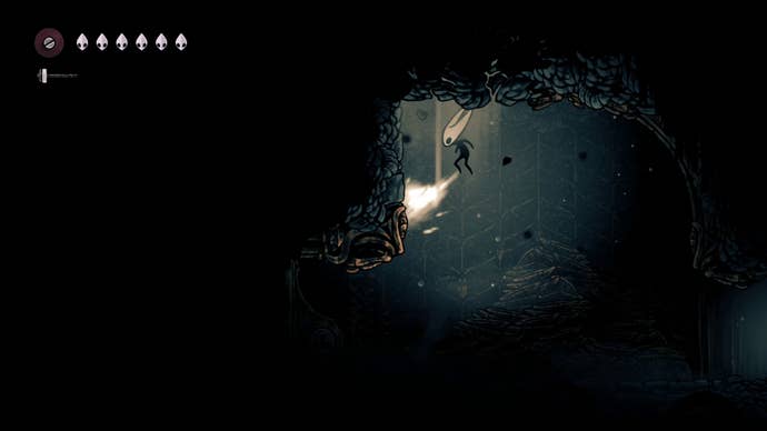 Hornet attacks a breakable ceiling in The Slab in Hollow Knight: Silksong