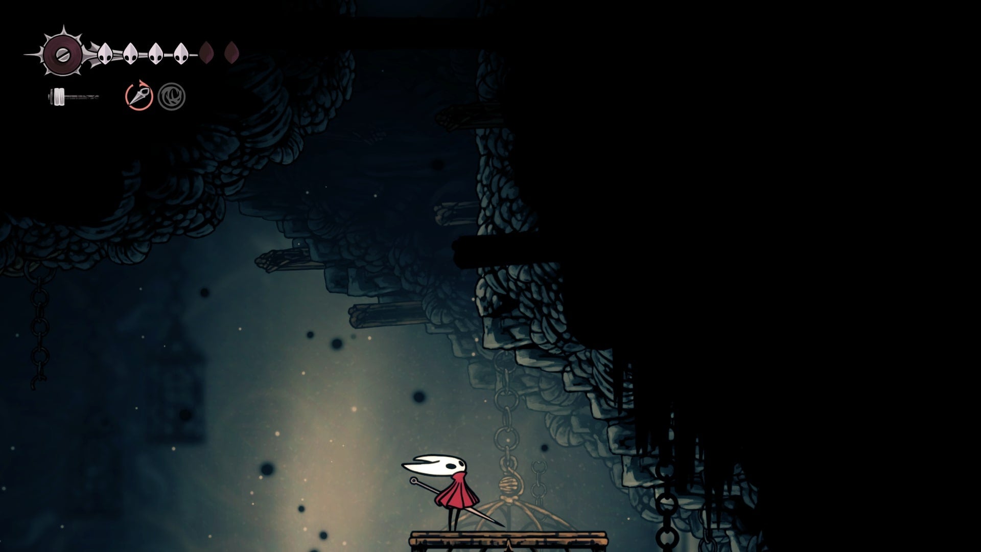 Hornet looks upwards at an exit in The Slab in Hollow Knight: Silksong