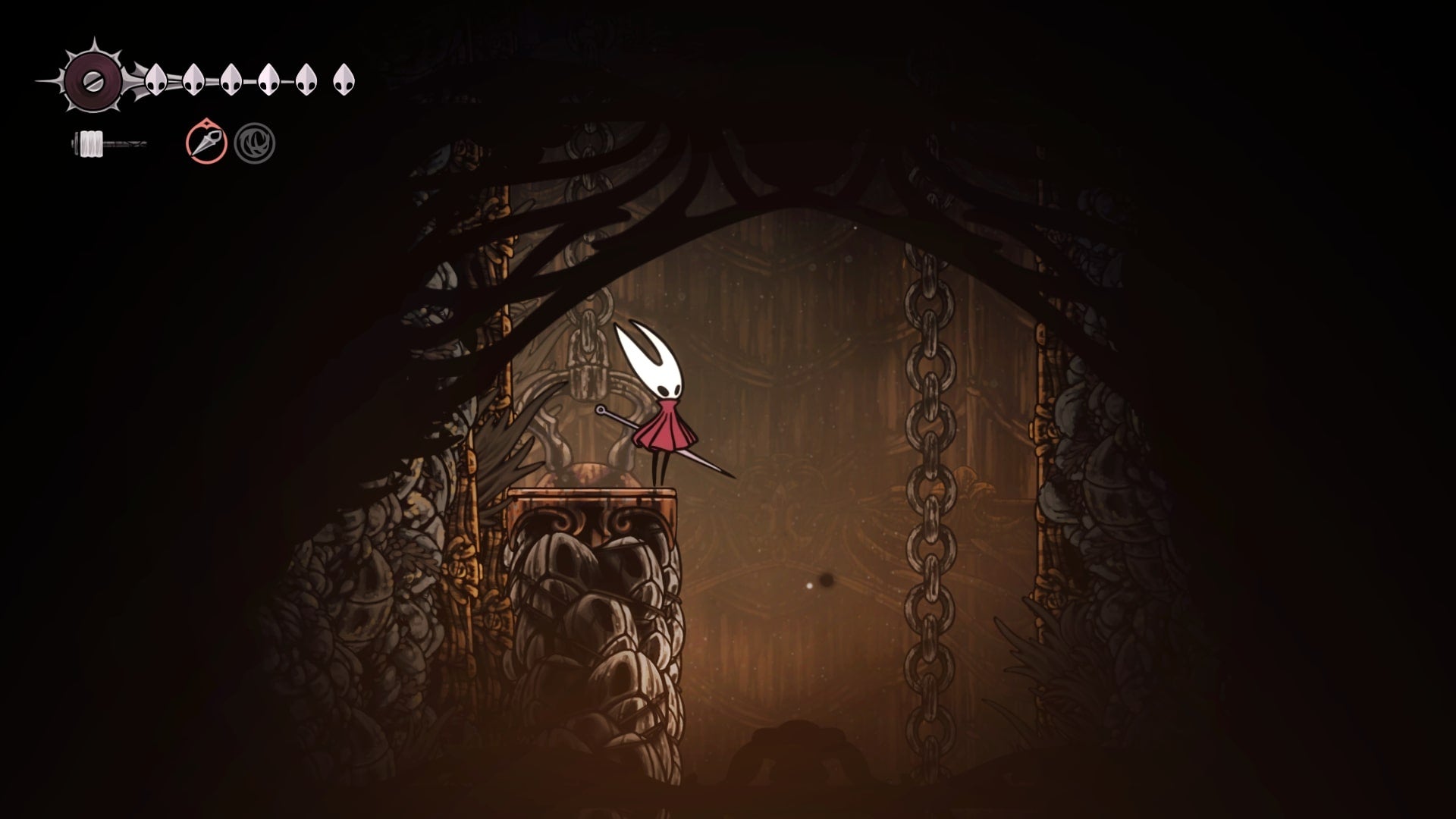 Hornet stands on a crate in the Underworks in Hollow Knight: Silksong