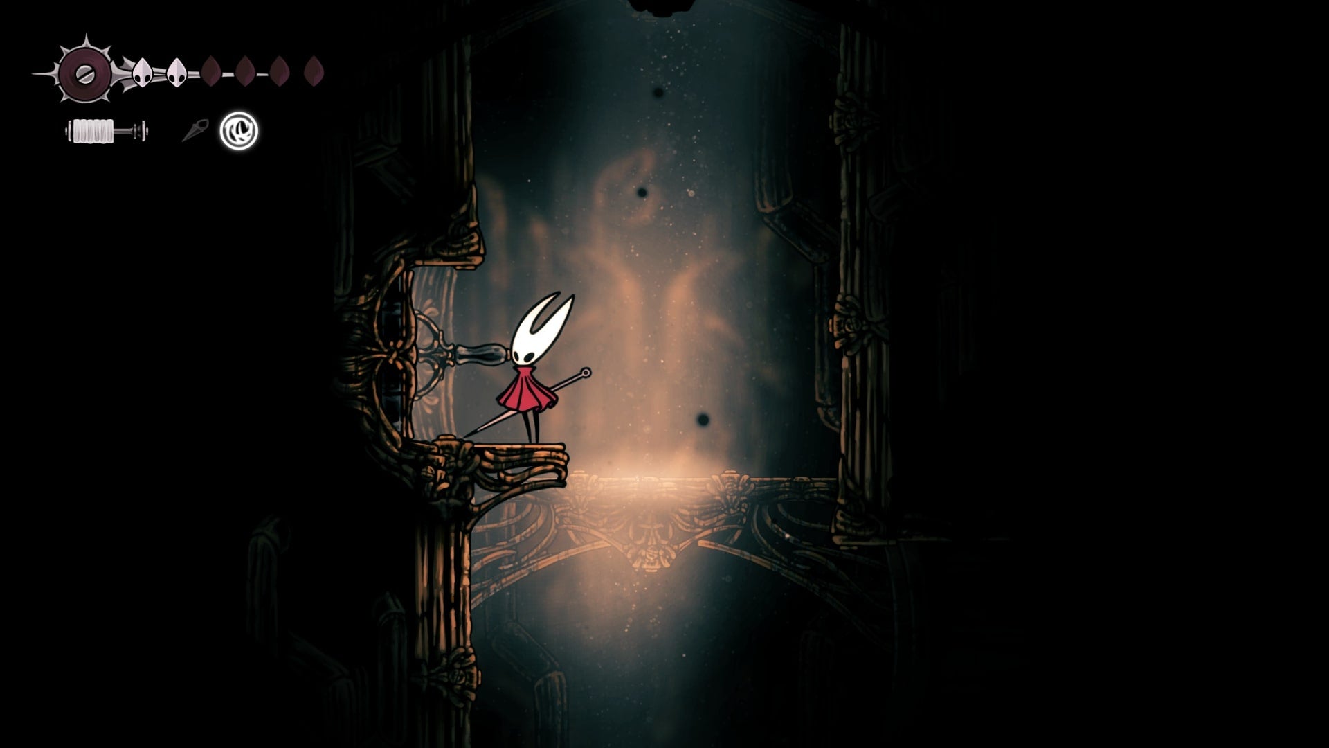Hornet stands beside a lever in the Underworks in Hollow Knight: Silksong