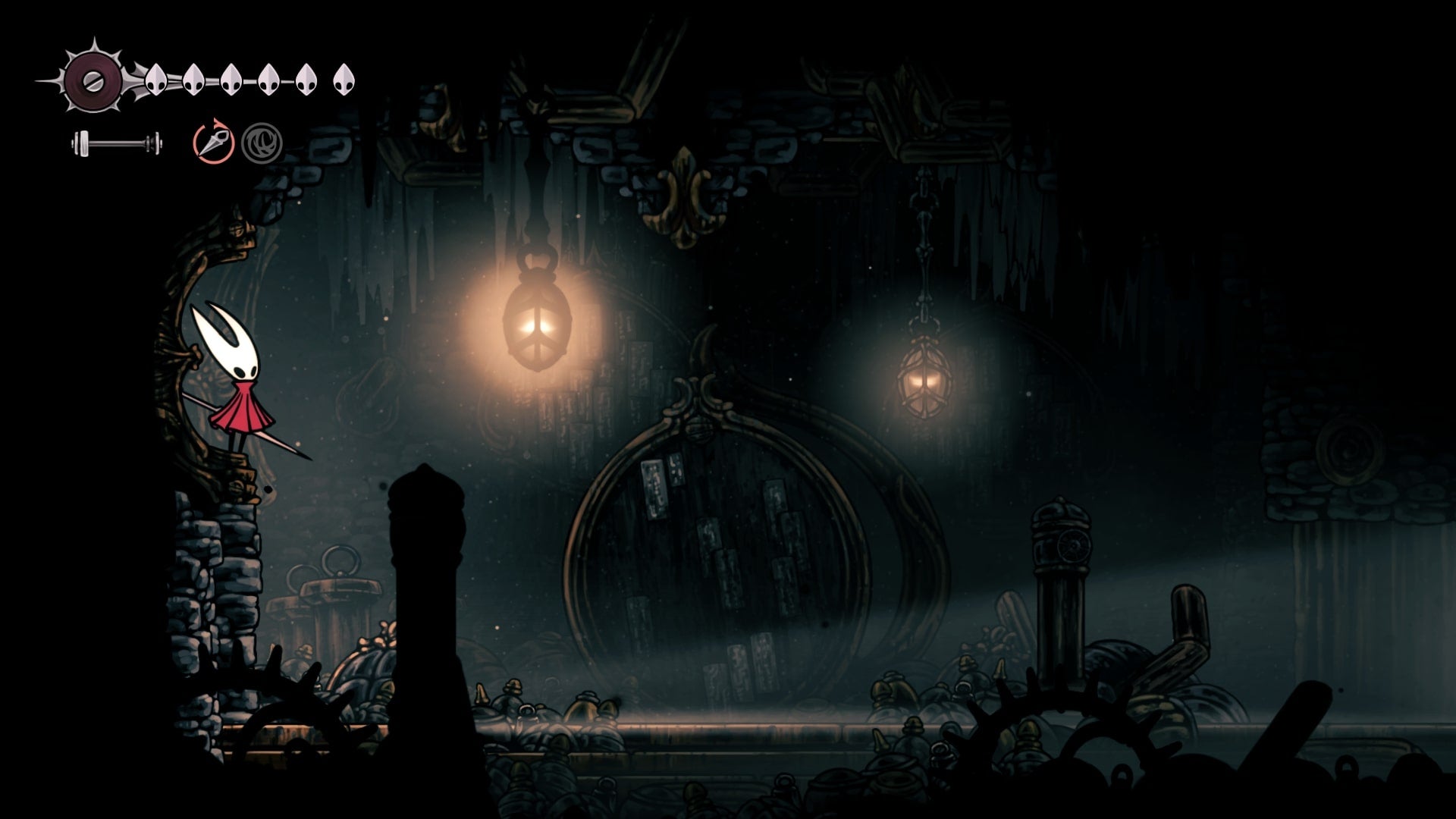 Hornet stands where a breakable gate should be in the Underworks in Hollow Knight: Silksong