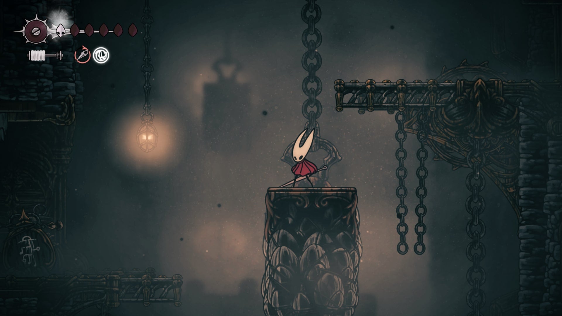 Hornet stands on a crate near a sign in the Underworks in Hollow Knight: Silksong
