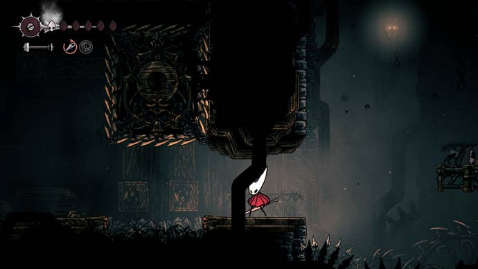 Hornet stands beside a spiked block in the Underworks in Hollow Knight: Silksong