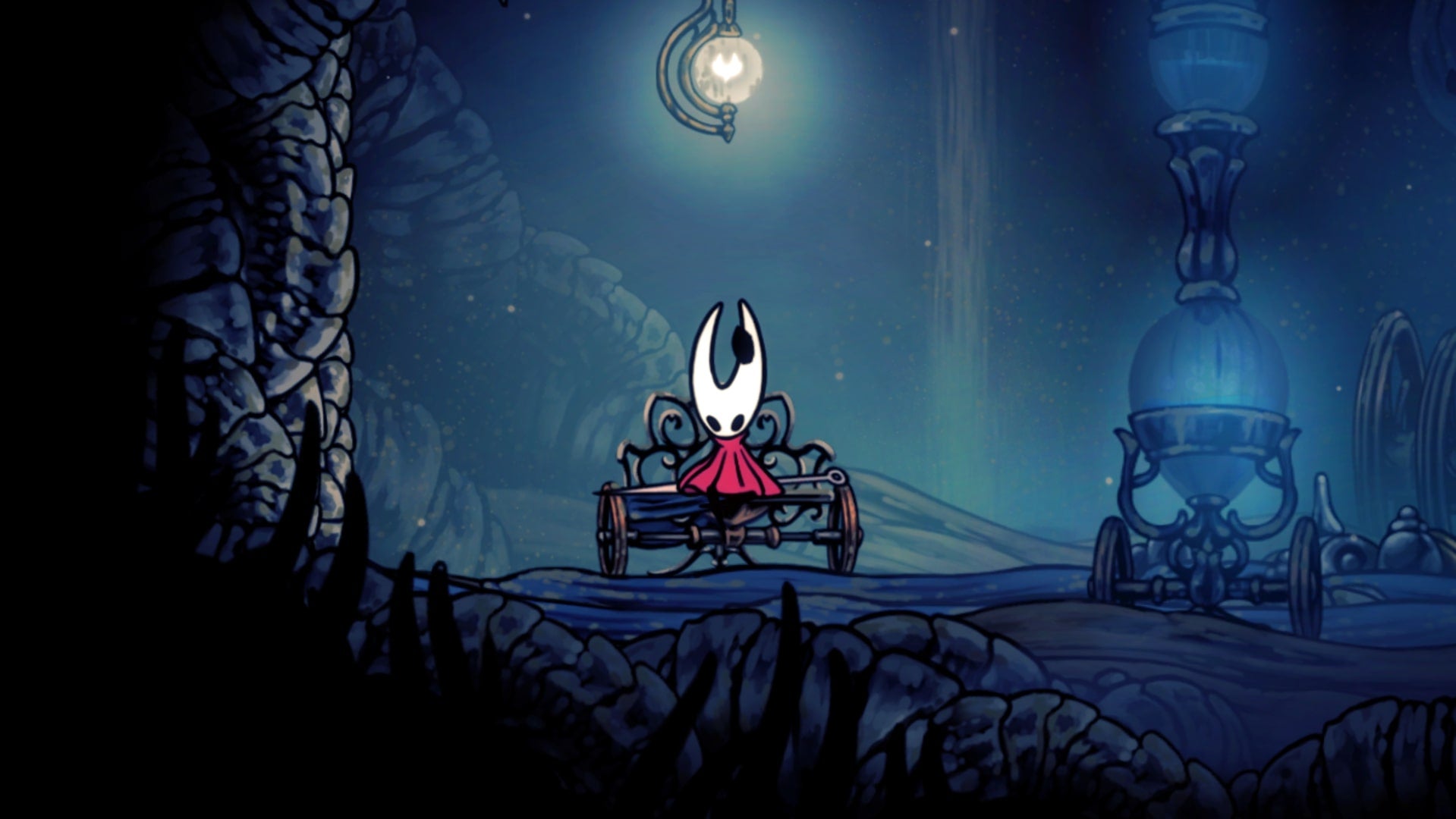Hornet rests at the Bench in the Wormways in Hollow Knight: Silksong.
