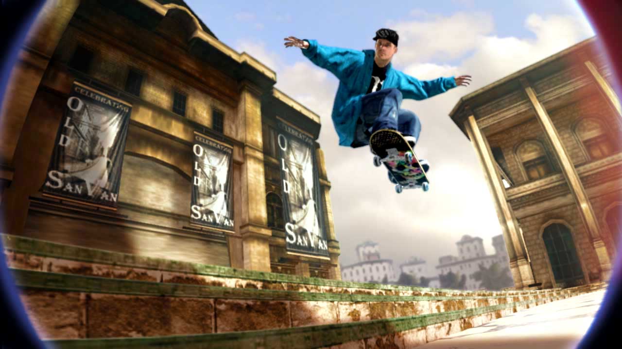 A skateboarder in a blue jacket doing a big jump near some buildings, framed against the clouds, from Skate 2 in 2009 - 6