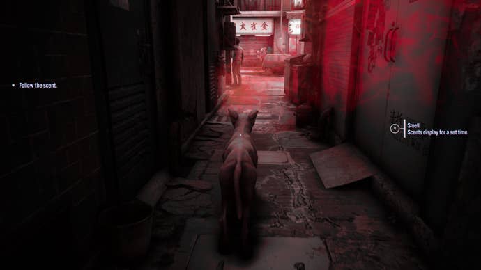 A screenshot from Slitterhead showing a stray dog in the shadows of an alleyway. A stylised red mist wafts in from the main street, which the dog is encouraged to follow. The on-screen text says: “Follow the scent” on the left and “Small - scents display for a set time” on the right.