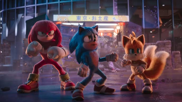 Sonic 3 film trailer screenshot showing Knuckles Sonic and Tails posing in a Tokyo street