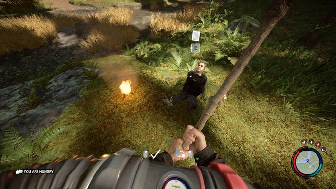 The player starts a fire next to Kelvin in Sons of the Forest