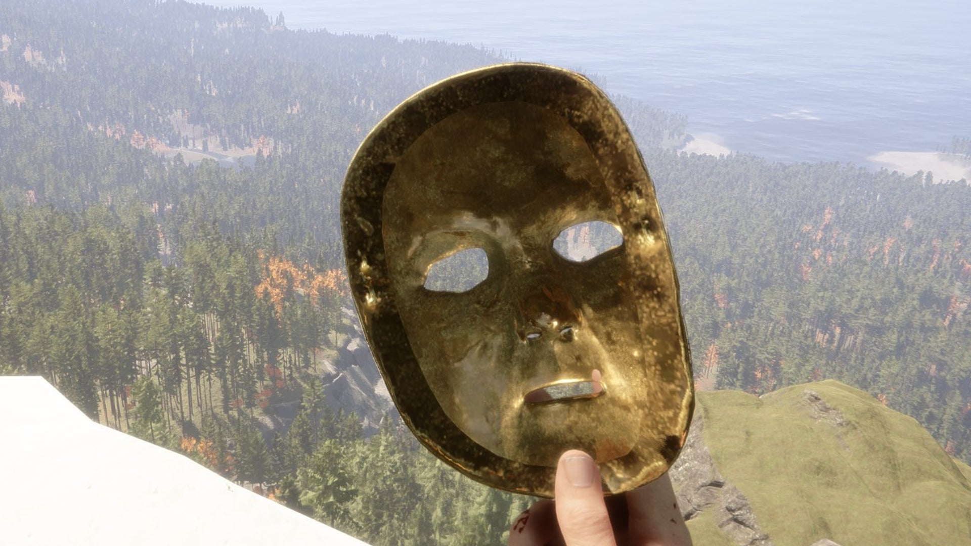 Sons Of The Forest player holds the Golden Mask on a snowy mountain overlooking the forest below. - 1