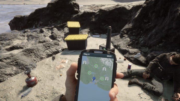 A player stares at their GPS on the beach in Sons Of The Forest.