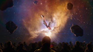 A character flies through space on a screen that essentially engulfs the people watching