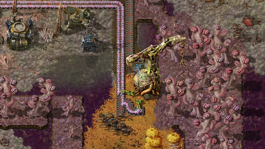A factory product line winding through a weirdly coloured alien landscape in Factorio