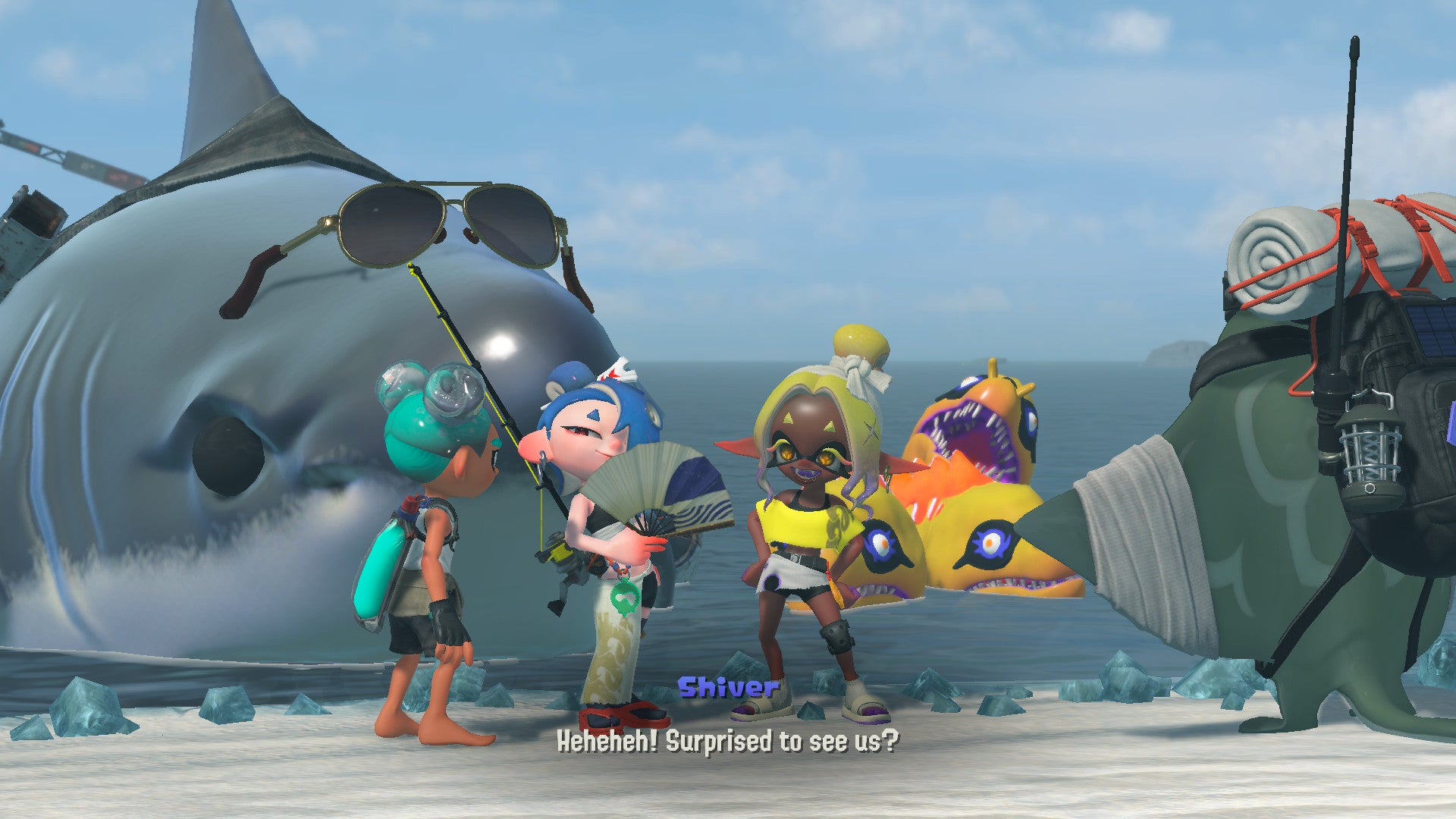 Splatoon Raiders screenshot showing you chatting with other inklings on a beach in front of a big shark wearing sunglasses