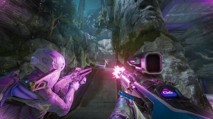 Two people firing at a third in a darker, rocky area in Splitgate 2