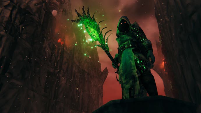 A mage holds a glowing green staff, with tall Gothic towers looming in the background behind her.