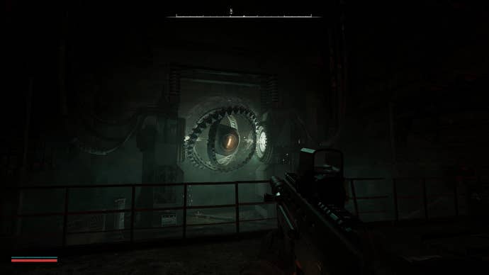 The player aims at a large rotating mechanical device in Stalker 2