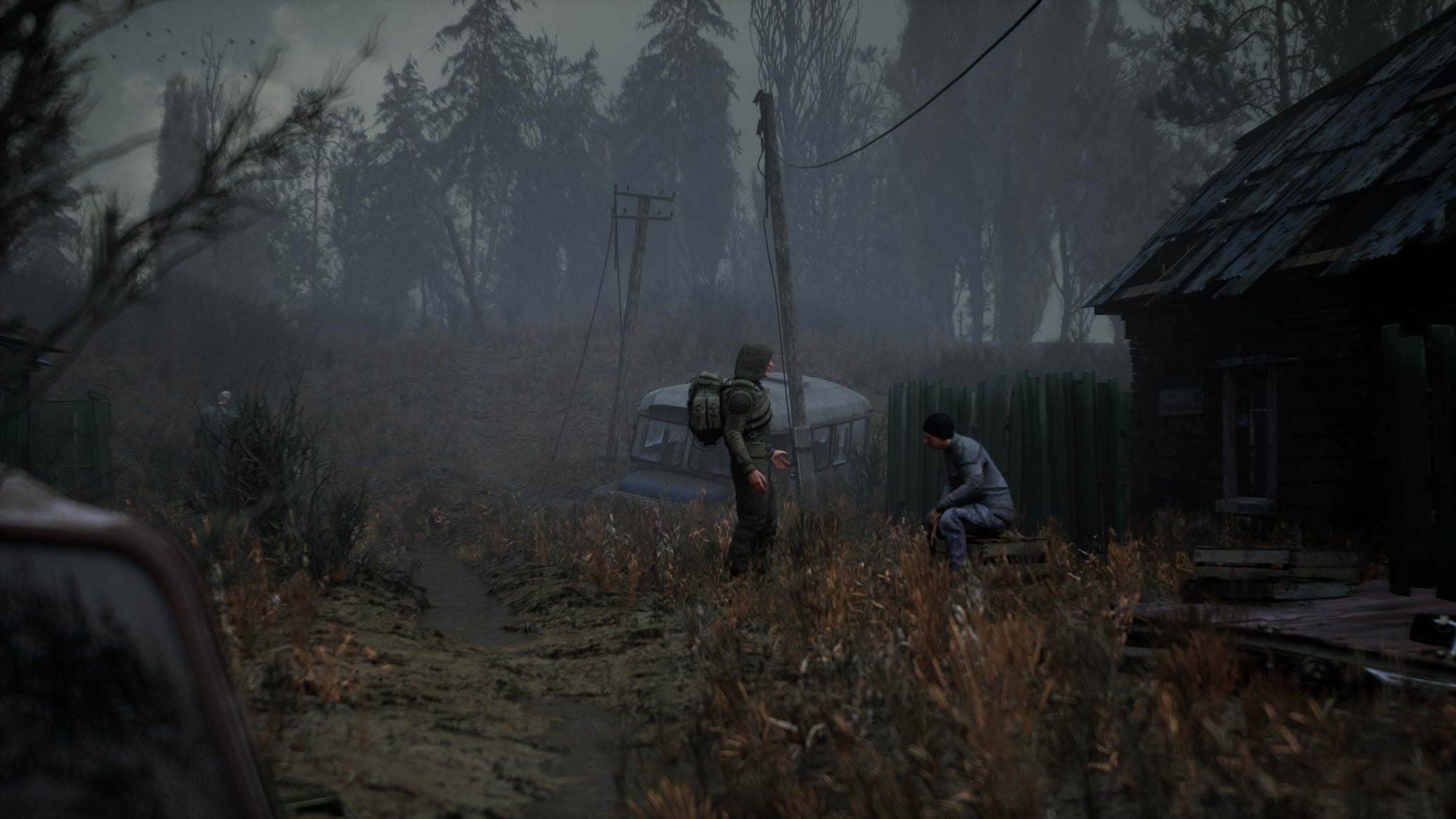 Two stalkers can be seen talking to one another outside a house in Stalker 2 - 1