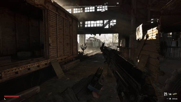The player reloads their gun while in a depot in Stalker 2
