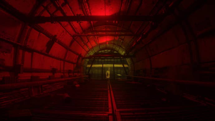 Skif walks through a tunnel illuminated by red light in Stalker 2