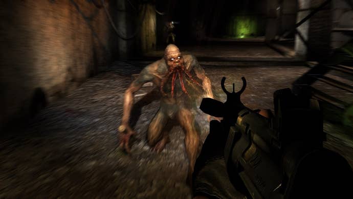 A creature with four tentacles hanging from its mouth attacks the player in a dark corridor in Stalker: Shadow of Chernobyl