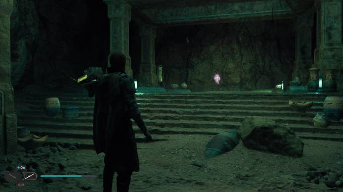 Star Wars Jedi: Survivor screenshot showing Cal stood in a dark room, dimly lit with a green hue. There’s a crackling orb hovering in the air up ahead.