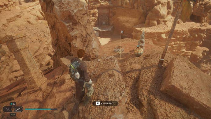 Star Wars Jedi: Survivor screenshot showing Cal stood on the edge of a rocky cliff in the desert.