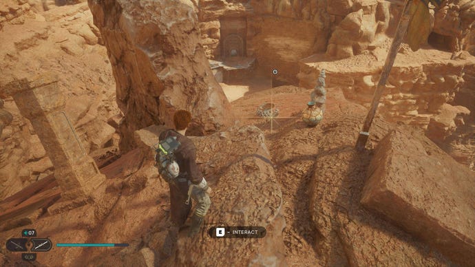 Star Wars Jedi: Survivor screenshot showing Cal stood on the edge of a rocky cliff in the desert.