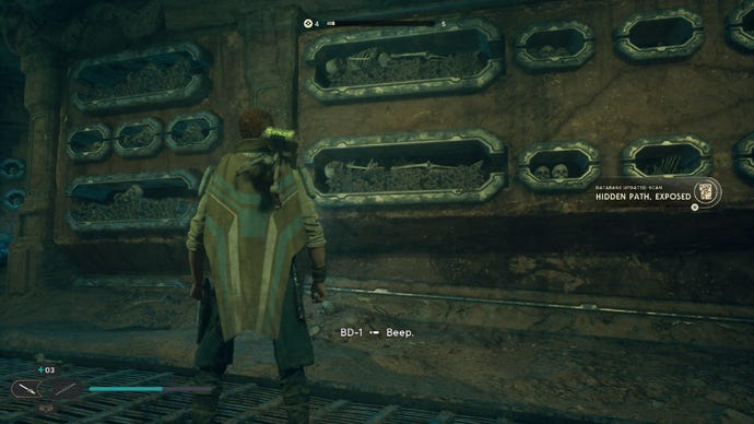 Star Wars Jedi: Survivor screenshot showing Cal stood staring at some skeletons in the wall of a catacomb.