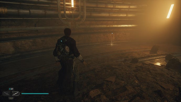 Star Wars Jedi: Survivor screenshot showing Cal stood in a cave tunnel lit with a warm orange hue, staring at a glinting treasure.