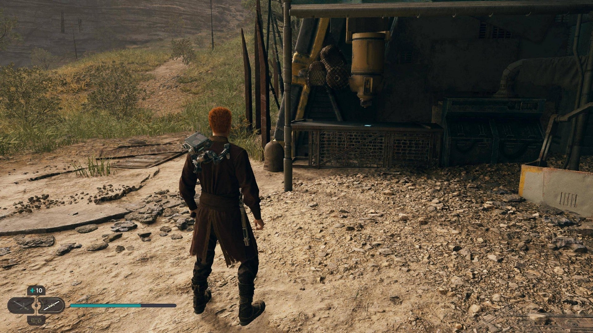 Star Wars Jedi Survivor screenshot showing Cal stood near a scannable device on a table.