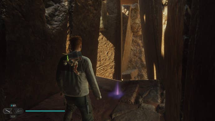Star Wars Jedi Survivor screenshot showing Cal stood on a dark sandy ledge, near a purple Essence on the floor.