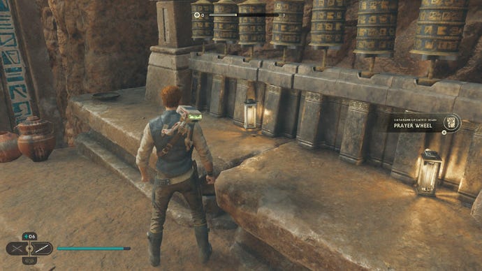 Star Wars Jedi Survivor screenshot showing Cal standing by some prayer wheels.
