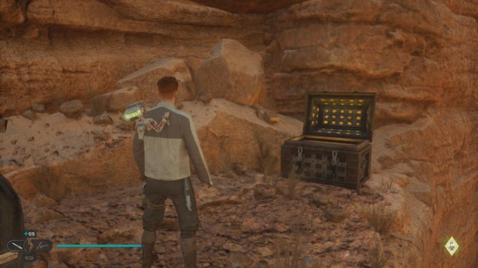 Star Wars Jedi Survivor screenshot showing Cal stood near an open chest on a sandy ledge.