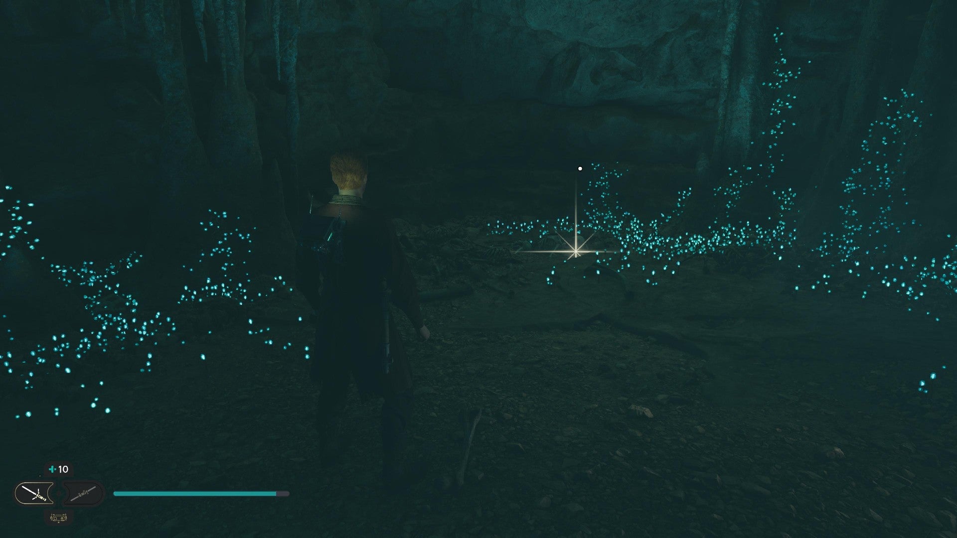 Star Wars Jedi Survivor screenshot showing Cal stood near a glistening Datadisc in a dark cave.