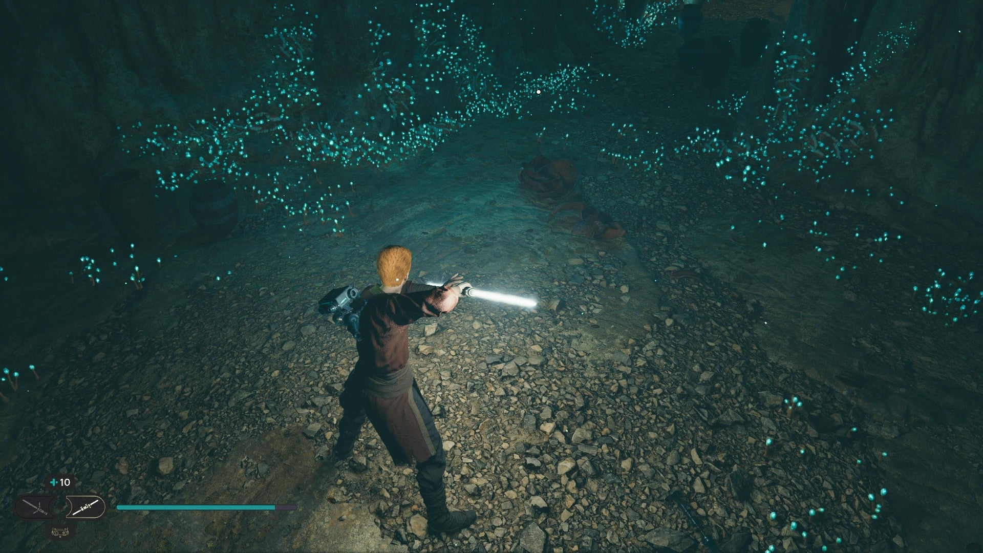 Star Wars Jedi Survivor screenshot showing Cal stood near a glistening Datadisc in a dark cave.