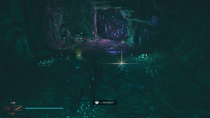 Star Wars Jedi Survivor screenshot showing Cal stood near a glistening Datadisc in a dark cave.