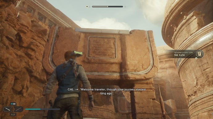 Star Wars Jedi: Survivor screenshot showing Cal staring up at a sand-covered rock arch in the desert.