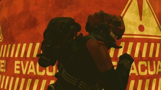 photo mode view of character in vanguard armor runing by a red and yellow evacuate sign