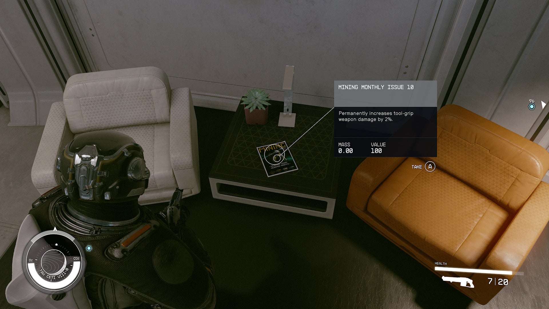 third person view of looking at a mining monthly isue skill book in a table between a white and orange chair