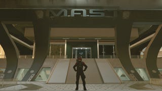 photo mode view of character in vanguard armor posing outside of mast building
