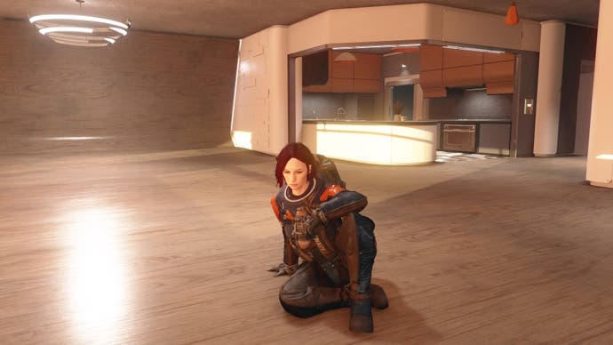 photo mode view of character in vanguard armor and no helemt sitting on floor of empy penthouse apartment