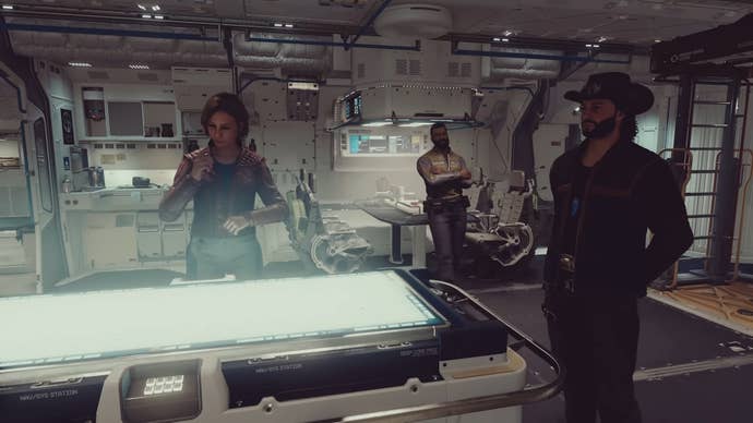 Sarah, sam and barret near a glowing nav system on a ship.