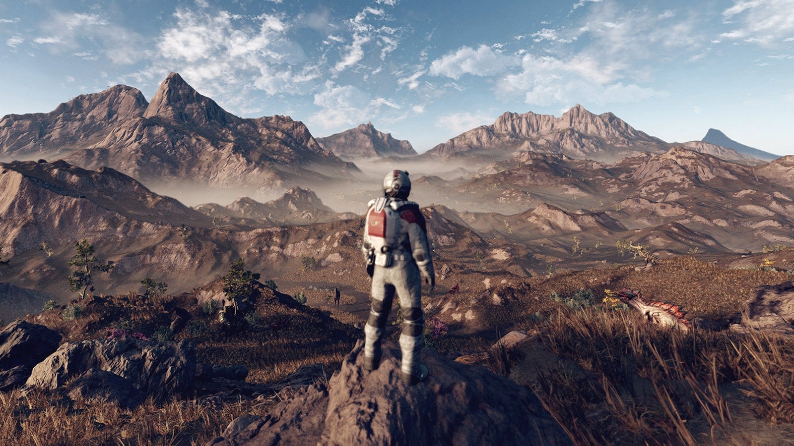 Person in a white space suit looking at an alien mountain planet landscape and skyline.