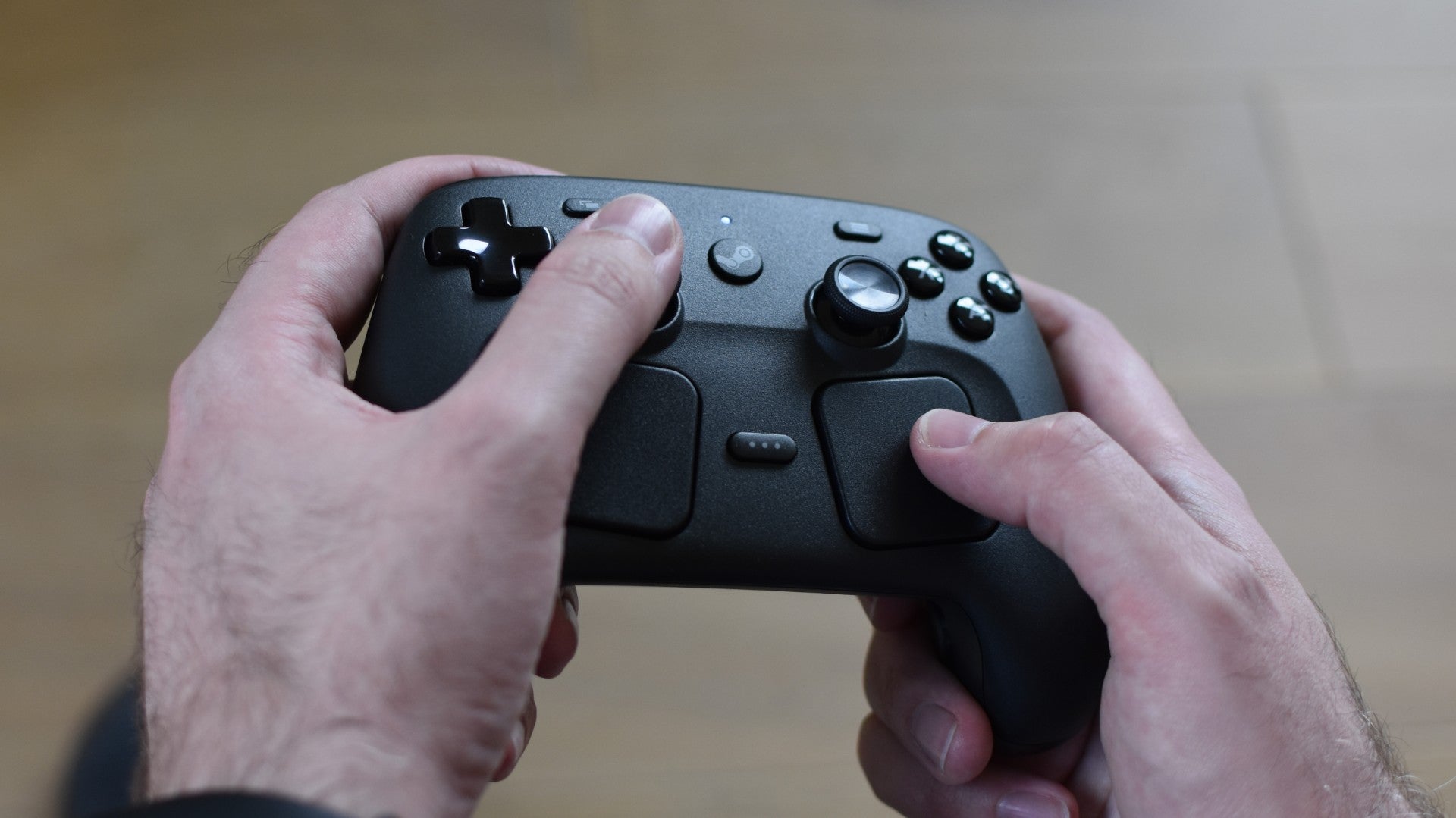 A Steam Controller being played, thumbs using both the joysticks and trackpads.